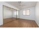 Bright bedroom with mirrored closet doors and wood flooring at 1013 Falconhead Ln # 101, Las Vegas, NV 89128