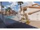 Community pool with surrounding buildings and landscaping at 1013 Falconhead Ln # 101, Las Vegas, NV 89128