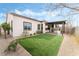 Landscaped backyard with artificial turf and covered patio at 10262 Super Jovian St, Las Vegas, NV 89143