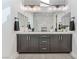 Spa-like bathroom with double vanity and marble tile at 10262 Super Jovian St, Las Vegas, NV 89143