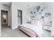 Bedroom with pink bed frame, closet, and floral wall decor at 10262 Super Jovian St, Las Vegas, NV 89143