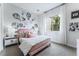 Charming bedroom with a pink bed frame, gray accent wall, and large window at 10262 Super Jovian St, Las Vegas, NV 89143