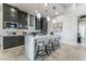 Modern kitchen with island, stainless steel appliances, and dark cabinetry at 10262 Super Jovian St, Las Vegas, NV 89143