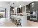 Modern kitchen with dark cabinetry and large island at 10262 Super Jovian St, Las Vegas, NV 89143