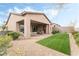 Artificial turf backyard with covered patio and gravel at 10270 Super Jovian St, Las Vegas, NV 89143