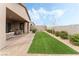 Artificial turf backyard with covered patio and gravel at 10270 Super Jovian St, Las Vegas, NV 89143