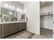 Elegant bathroom with double sinks, a walk-in shower, and a separate closet at 10270 Super Jovian St, Las Vegas, NV 89143