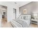 Spacious bedroom with gray accent wall, white bedding, and ample closet space at 10270 Super Jovian St, Las Vegas, NV 89143