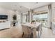 Bright dining area with modern light fixture and view to the backyard and living room at 10270 Super Jovian St, Las Vegas, NV 89143