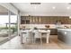 Kitchen dining area with modern light fixture and view to the backyard at 10270 Super Jovian St, Las Vegas, NV 89143