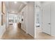 Light and airy hallway with hardwood floors, leading to living areas and bedrooms at 10270 Super Jovian St, Las Vegas, NV 89143