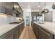 Modern kitchen with gray cabinets, quartz countertops, and a large pantry at 10270 Super Jovian St, Las Vegas, NV 89143