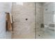 Walk-in shower with marble tile and pebble floor at 10270 Super Jovian St, Las Vegas, NV 89143