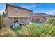 Landscaped backyard with covered patio and grassy area at 10597 Painted Bridge St, Las Vegas, NV 89179