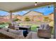 Covered patio with fire pit and seating area at 10597 Painted Bridge St, Las Vegas, NV 89179