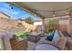 Covered patio with fire pit and seating area at 10597 Painted Bridge St, Las Vegas, NV 89179