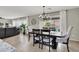 Elegant dining room with chandelier and seating for six at 10597 Painted Bridge St, Las Vegas, NV 89179