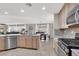 Open concept kitchen with island, stainless steel appliances, and view to Gathering room at 10597 Painted Bridge St, Las Vegas, NV 89179