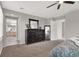 Main bedroom with large dresser and view of bathroom at 10597 Painted Bridge St, Las Vegas, NV 89179