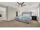 Main bedroom with large bed, walk-in closet, and ceiling fan at 10597 Painted Bridge St, Las Vegas, NV 89179