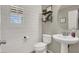 Small powder room with white pedestal sink at 10597 Painted Bridge St, Las Vegas, NV 89179