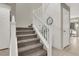 Elegant staircase with carpeted steps and white railing at 10597 Painted Bridge St, Las Vegas, NV 89179