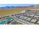Aerial view of a new construction community showcasing tennis courts and mountain views at 12457 Heritage Bend Dr, Las Vegas, NV 89138