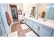 Clean and modern bathroom with dual sinks, and a glass-enclosed shower at 12457 Heritage Bend Dr, Las Vegas, NV 89138