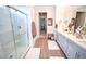 Bright bathroom featuring dual sinks, white countertops, and a modern glass-enclosed shower at 12457 Heritage Bend Dr, Las Vegas, NV 89138