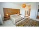 Bright bedroom with a stylish bed, unique light fixture, and an ensuite bathroom view at 12457 Heritage Bend Dr, Las Vegas, NV 89138