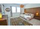 Stylish bedroom featuring a modern platform bed, wood headboard, and striking patterned rug at 12457 Heritage Bend Dr, Las Vegas, NV 89138