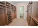 Organized walk-in closet featuring custom shelving and storage, with a bathroom view at 12457 Heritage Bend Dr, Las Vegas, NV 89138
