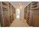 Spacious walk-in closet with custom wood shelving and ample storage space at 12457 Heritage Bend Dr, Las Vegas, NV 89138