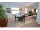 Modern dining area with a square table, stylish rug, and neon art at 12457 Heritage Bend Dr, Las Vegas, NV 89138