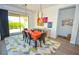 Bright dining room features a colorful patterned rug and access to outdoor living space at 12457 Heritage Bend Dr, Las Vegas, NV 89138