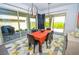 Modern dining room features large windows, stylish lighting and colorful geometric patterned rug at 12457 Heritage Bend Dr, Las Vegas, NV 89138