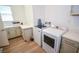 Functional laundry room with modern washer and dryer, counter space, and ample cabinetry at 12457 Heritage Bend Dr, Las Vegas, NV 89138