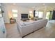 Spacious living room features a comfortable gray sofa and sliding glass doors at 12457 Heritage Bend Dr, Las Vegas, NV 89138