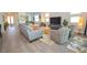 Open living area with stylish furnishings, including a gray sofa and patterned chairs at 12457 Heritage Bend Dr, Las Vegas, NV 89138