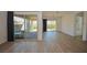 Spacious living room featuring wood-look floors and sliding glass doors to outdoor patio at 12457 Heritage Bend Dr, Las Vegas, NV 89138
