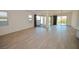 Living area with wood floors, window, and sliding doors to the backyard at 12457 Heritage Bend Dr, Las Vegas, NV 89138