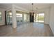 Open floor plan features wood-look flooring and sliding glass doors leading to outdoor living area at 12457 Heritage Bend Dr, Las Vegas, NV 89138