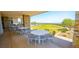 Outdoor covered dining area with tables, chairs, and a stunning view at 12457 Heritage Bend Dr, Las Vegas, NV 89138