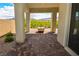 Paver patio under a covered porch, with a view of the green desert landscaping at 12457 Heritage Bend Dr, Las Vegas, NV 89138