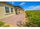 Wide shot of backyard patio with brick ground cover and landscaping along the back fence at 12457 Heritage Bend Dr, Las Vegas, NV 89138