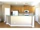 Modern kitchen featuring wood cabinets and breakfast bar at 1350 Crystal Hill Ln # 3, Henderson, NV 89012