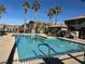 Community swimming pool with surrounding palm trees at 1350 Crystal Hill Ln # 3, Henderson, NV 89012