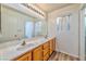 Bathroom with double sinks and light wood cabinets at 1605 Calle Montery St, Las Vegas, NV 89117