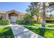 Tan stucco home with double doors and manicured lawn at 1605 Calle Montery St, Las Vegas, NV 89117