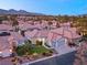 Single-story home with a two-car garage and lush landscaping at 1613 Shadow Rock Dr, Las Vegas, NV 89117